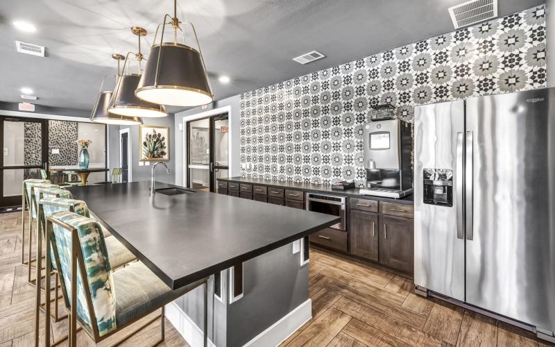 a kitchen with a bar and a dining table