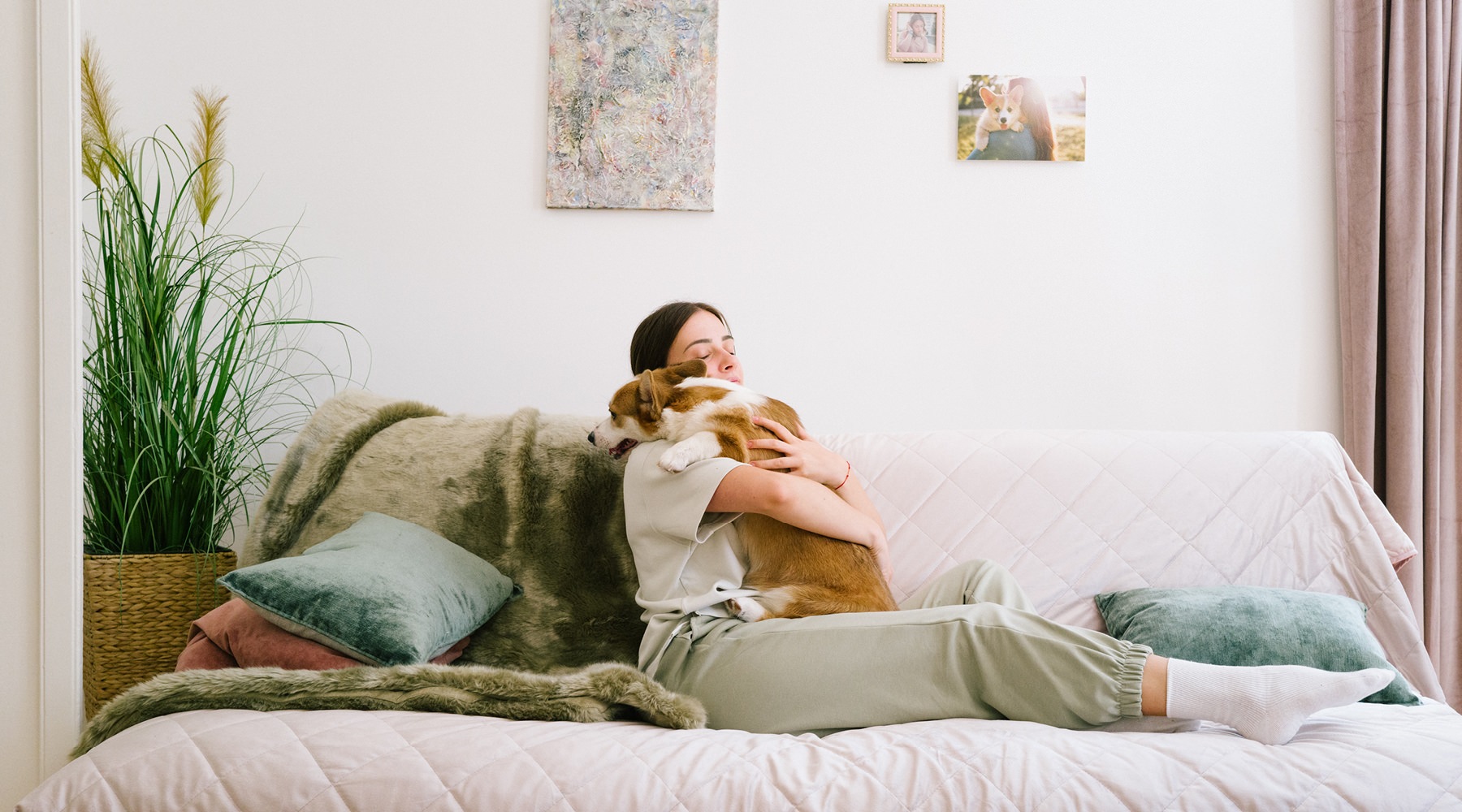 a woman hugging her cute little dog in a large room