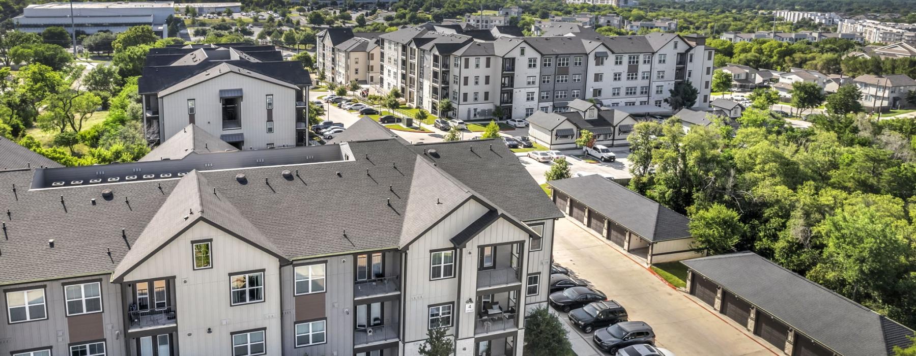 a group of buildings with cars parked in front of them